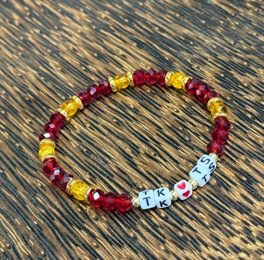 Beaded bracelet with letter beads on a wooden surface