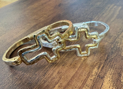 Gold and silver bracelet on a wooden surface
