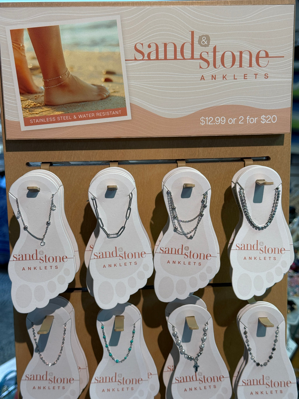 Display of Sandstone Anklets with packaging and promotional text.
