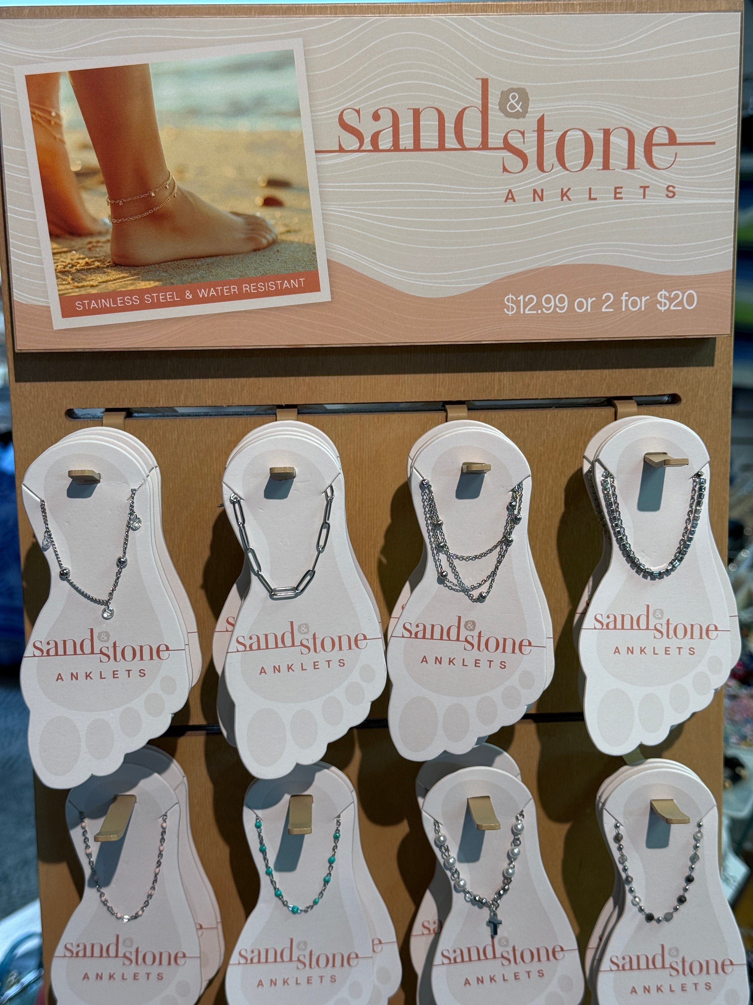 Display of Sandstone Anklets with packaging and promotional text.