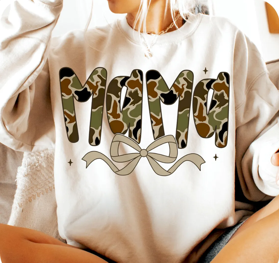 Tan sweatshirt with camouflage 'MOM' text and a bow design.