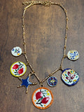Necklace with colorful ceramic pendants on a wooden surface
