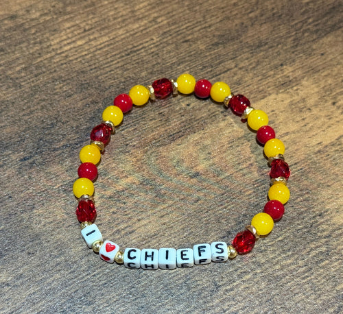 Beaded bracelet with 'I ❤️ CHIEFS' on a wooden surface