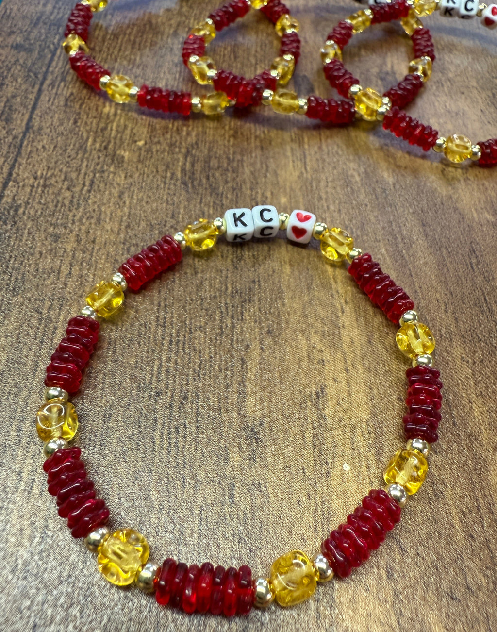 Beaded bracelet with red and yellow beads on a wooden surface