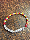 Bracelet with letter beads on a wooden surface