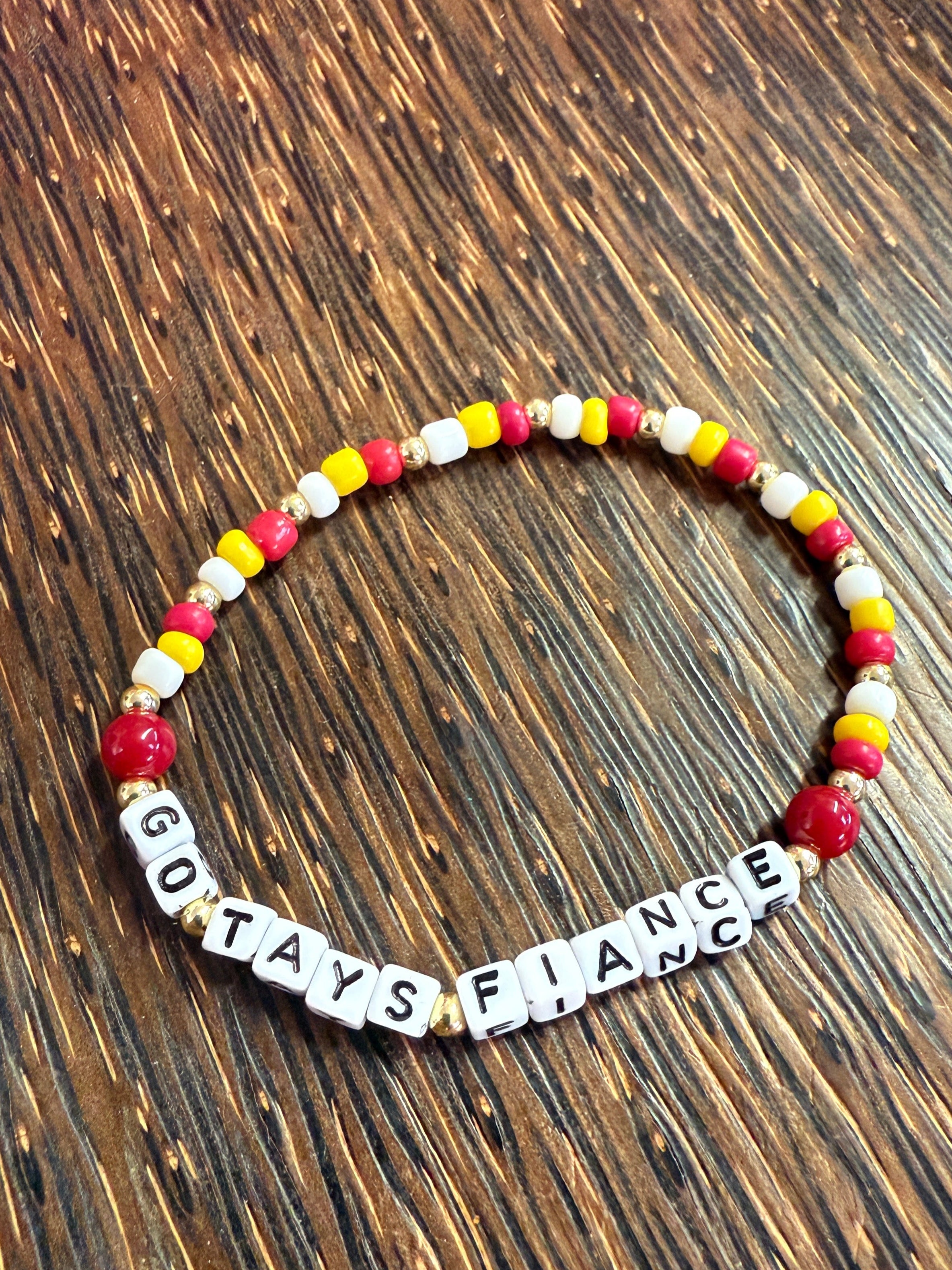 Bracelet with letter beads on a wooden surface