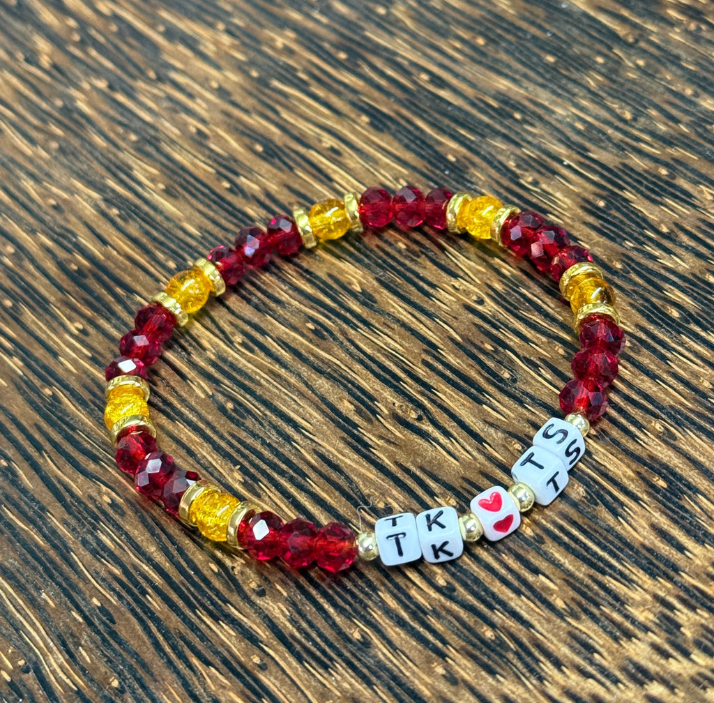 Beaded bracelet with letter beads on a wooden surface