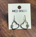 Heart-shaped earrings on a 'Paco Designs' card on a wooden surface
